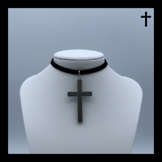 Black choker necklace with a silver cross pendant on a mannequin bust against a light gray background.
